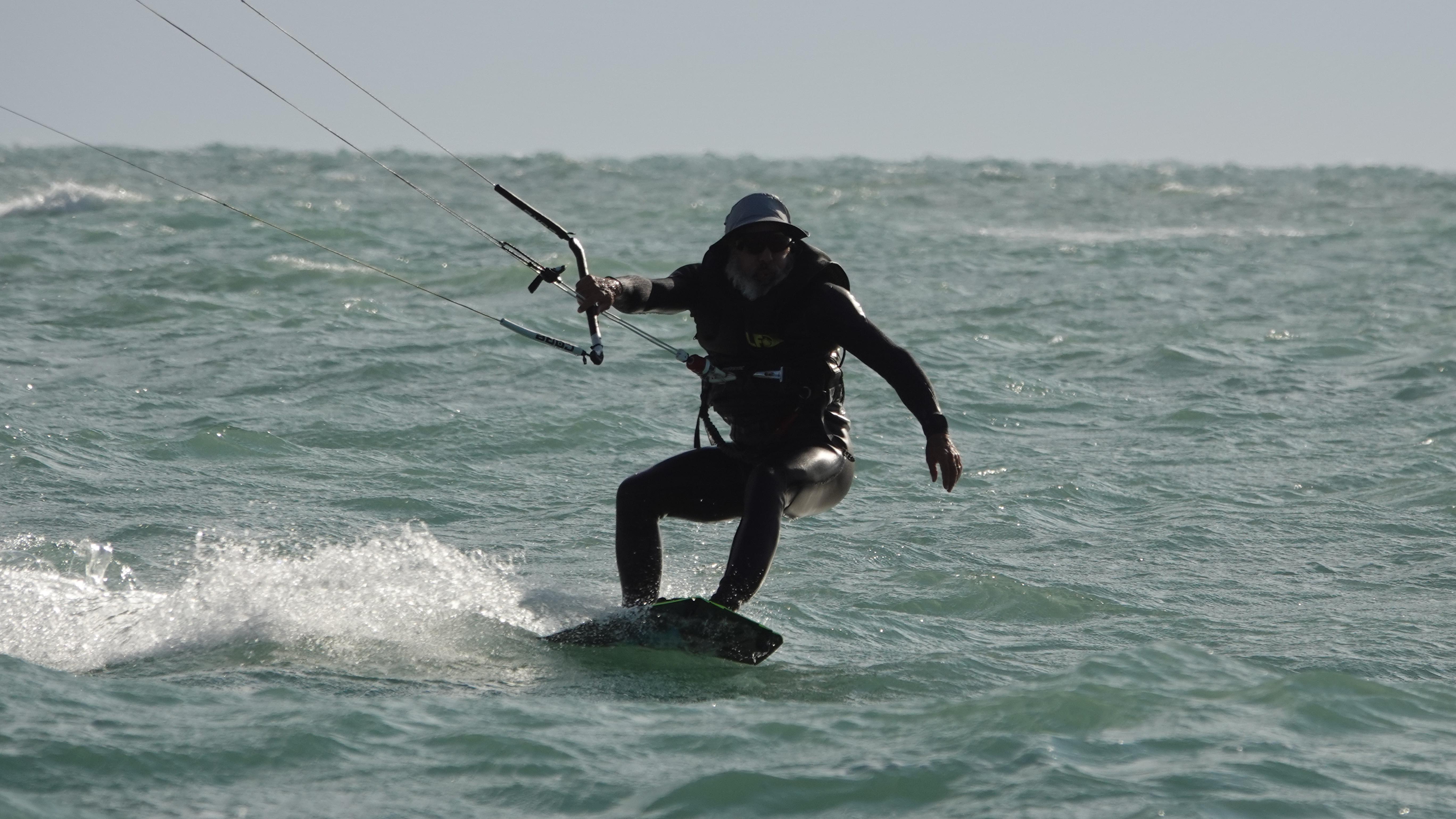 Close-up kiteboarding action with water spray