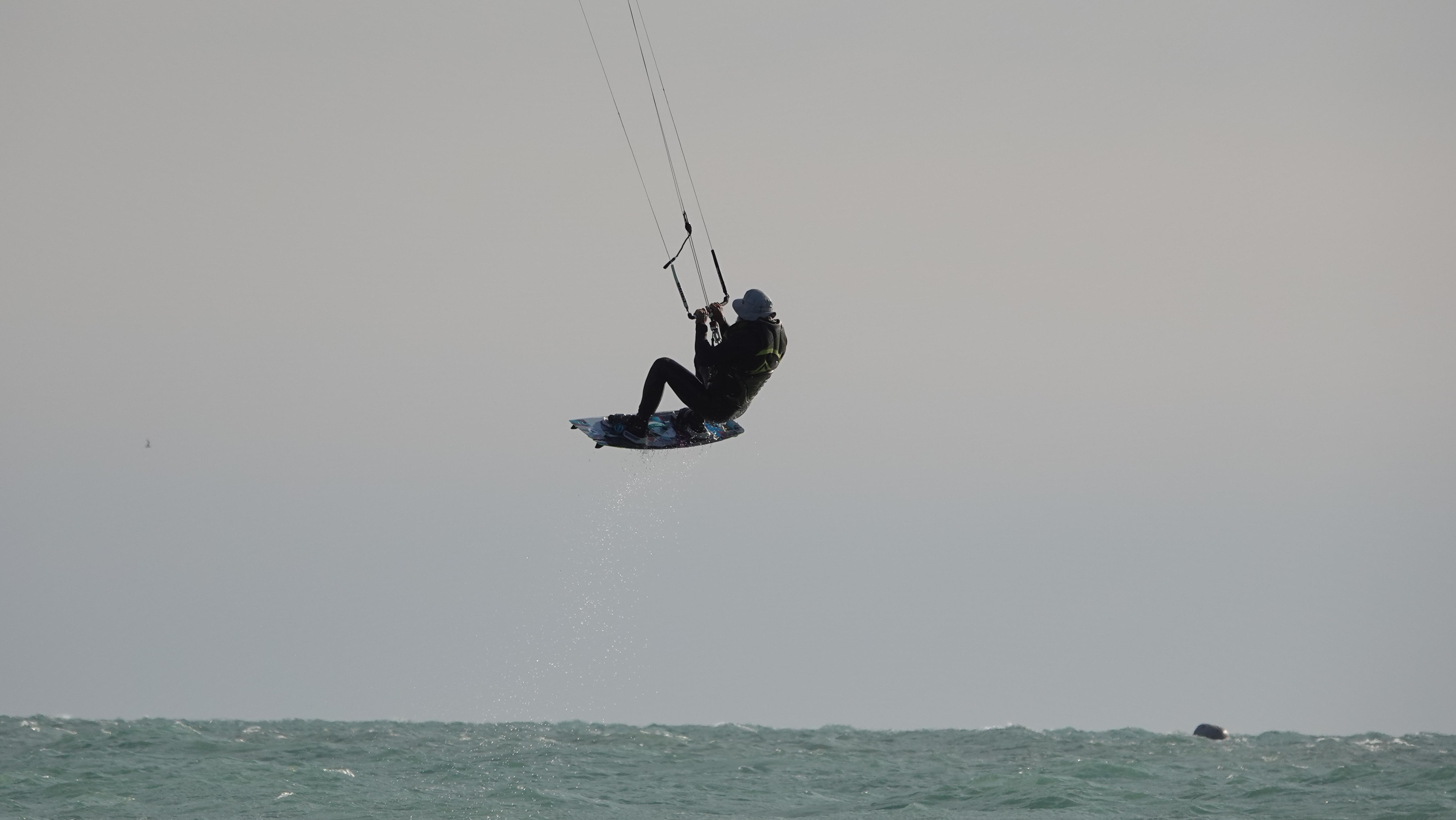 Kiteboarder suspended in mid-air with perfect form